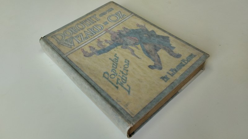 Tweedehands boek: Dorothy and the Wizard in Oz van auteur L. Frank Baum - Engelstalige hardcover met stofomslag (beschermfolie aanwezig). Omslag verkleurd en slijtage aan randen; binnenwerk met duidelijke ouderdomsvlekjes (foxing), boekwerk los in kaft.