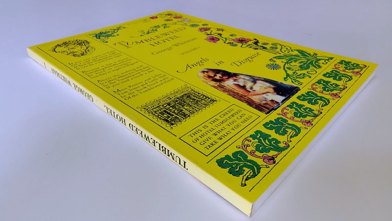 Tweedehands boek: Tumbleweed Hotel: Volume 1, Angels in Disguise van auteur George WHitman - Engelstalige paperback met rechte rug zonder leesvouwen en lichte verkleuring. Minimale gebruikerssporen puntjes kaft. Orginele stempel van Shakespeare & Company voorin.