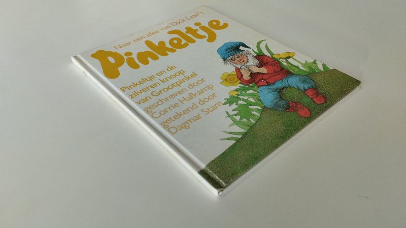 Tweedehands boek: Pinkeltje en de zilveren knoop van Grootpinkel van auteur Corrie Hafkamp - In goede staat. Nederlandstalige hardcover. Kaft en pagina's zijn netjes met lichte gebruikssporen passend bij de leeftijd. Ex Libris stempel voorin.