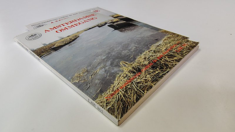Tweedehands boek: Amsterdamse Ommegang van auteur Samengesteld - Paperback met lichte gebruikerssporen randen kaft en lichte verkleuring. Binnenwerk onbeschreven en netjes. Inclusief bijbehorende wandelkaart.